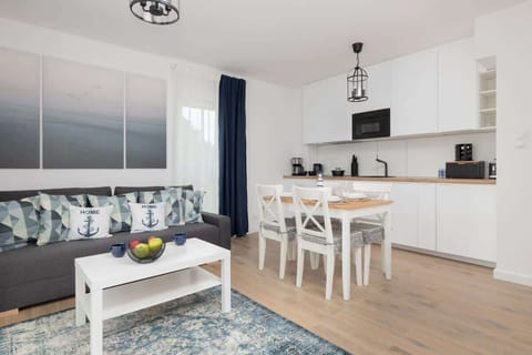 The living area features a sleek coffee table and a flat-screen television.