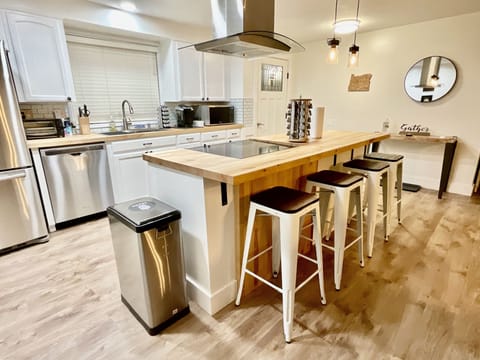 Kitchen is equipped with cooking essentials, olive oil, and an array of spices.