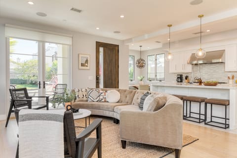 Living room features a fireplace and couch, perfect for a movie night after swimming and surfing at Corona Del Mar State Beach Park (a 4-minute drive away).