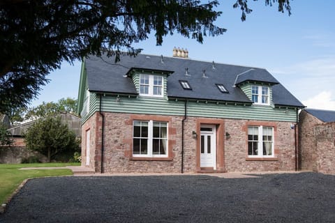 Dryburgh Farmhouse - front view of the property showing its pretty red sandstone exterior