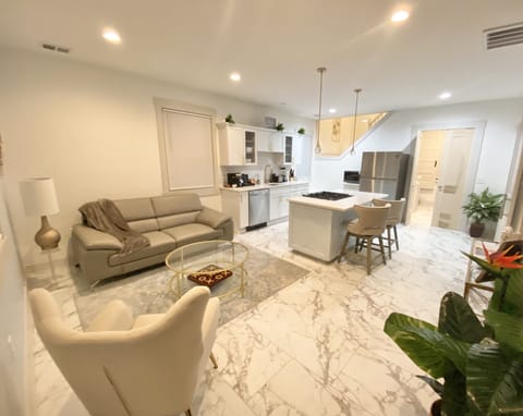 Living Room/Kitchen with soft and bright lighting. 