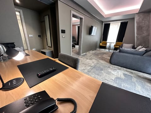 Deluxe Suite | Living area | 100-cm LCD TV with cable channels, TV, heated floors