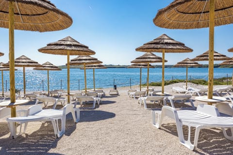 Private beach, white sand, sun loungers, beach umbrellas