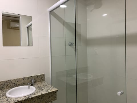 Economy Triple Room | Bathroom | Shower, rainfall showerhead, towels