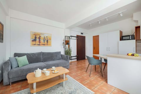 Another angle of the living and kitchen areas, showcasing the open floor plan with dining, sitting, and kitchen spaces.