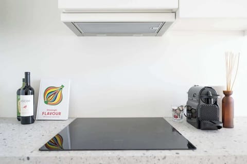 Our modest yet fully functional kitchenette featuring an electric stove, range hood and coffee machine to kickstart your day.