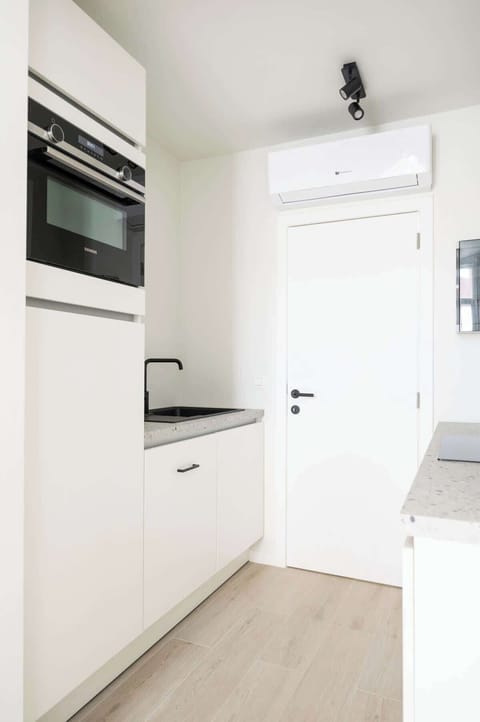 The kitchen has plenty of cabinet space for you to store your belongings