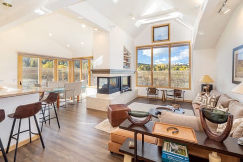 Bright and open sunken living room with fireplace, sectional and VIEWS