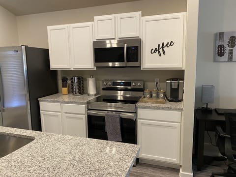 Fully stocked kitchen featuring coffee bar, RO water, pots, pans, dishes, silver