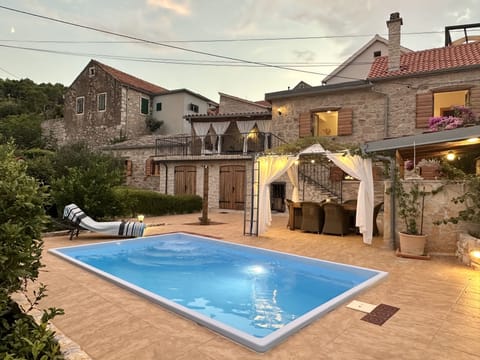 The villa and the swimming pool at sunset