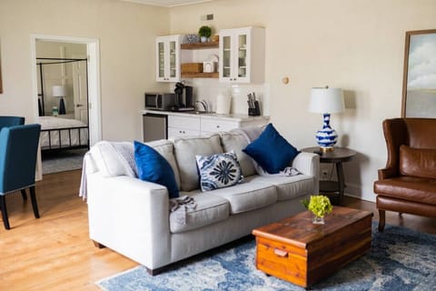 The sitting area doubles as an additional sleeping area by utilizing the sleeper sofa. Additional bedding for the sleeper sofa is located in the basket and cupboard near the accent chair.