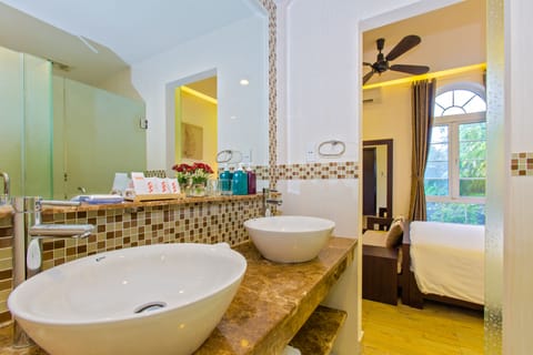 Deluxe Family Connecting Door | Bathroom | Designer toiletries, hair dryer, slippers, towels