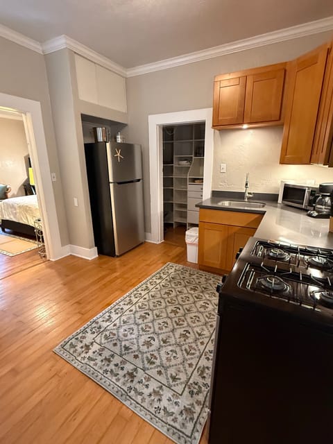 Kitchen loaded with gas stove, dishwasher, microwave, coffee maker and toaster.
