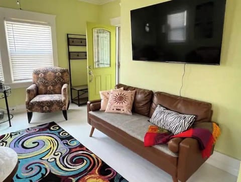 2 couches, 2 chairs and a big TV in the living room