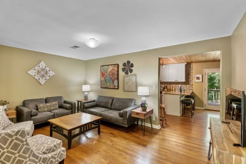 Comfy living room w TV is open to dining room for flow of conversation