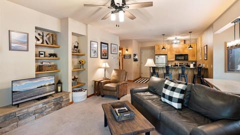 Open concept living room with a full size sofa sleeper, HDTV with streaming capabilities, and a gas fireplace to enjoy after a long day on the slopes.