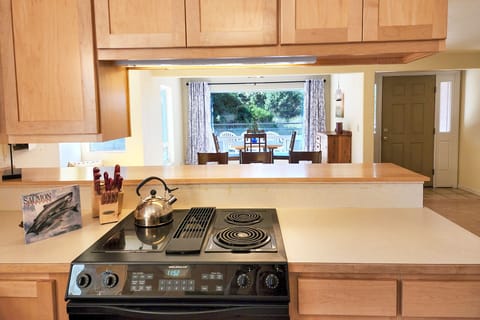 The pass through kitchen to table is convenient for the cook.