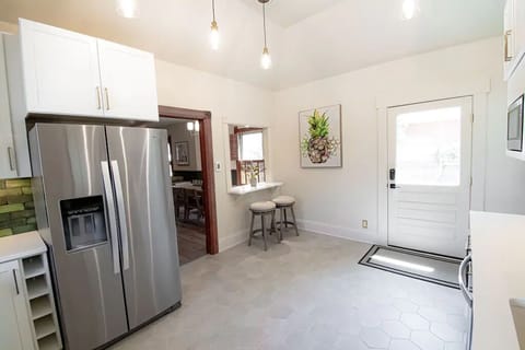 The eat-in bar opens to the living/dining space.  Walk out to the porch and yard.