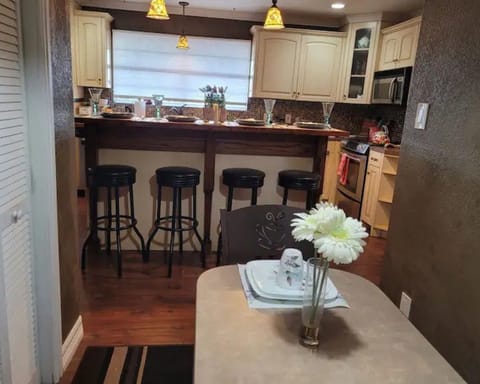 Dining table bar oven stovetop microwave large scenic kitchen window Coffee area