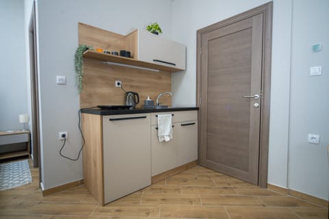 Standard Studio Suite | Private kitchen | Fridge, stovetop, electric kettle, cleaning supplies