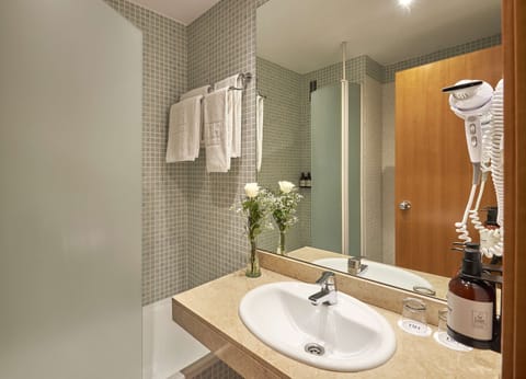 Bathtub, eco-friendly toiletries, hair dryer, towels