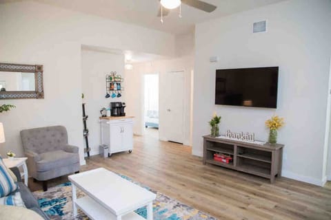 Living room with a 55" TV, and the coffee bar