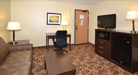 Suite, 1 King Bed, Non Smoking, Fireplace (One-Bedroom, Hot Tub) | Living area | 32-inch LCD TV with cable channels, TV