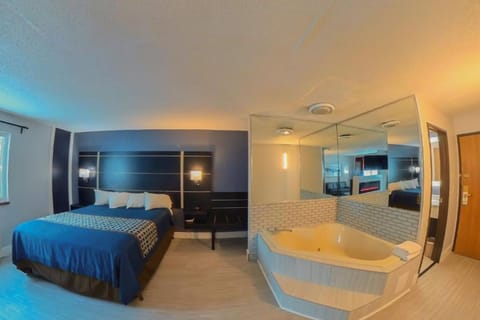 1 King Suite Jacuzzi, Non Smoking | Hypo-allergenic bedding, in-room safe, laptop workspace, blackout drapes