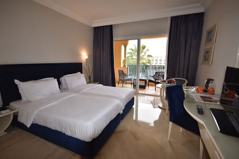 Deluxe Room, Garden View | Minibar, in-room safe, iron/ironing board, free cribs/infant beds