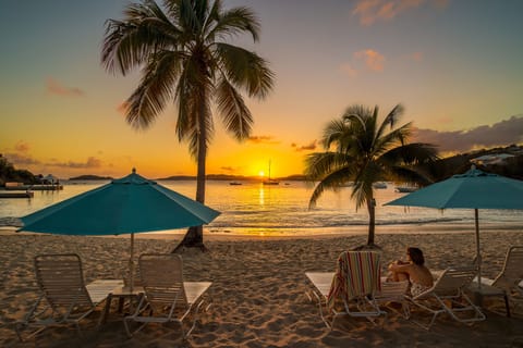 On the beach, white sand, sun loungers, beach umbrellas