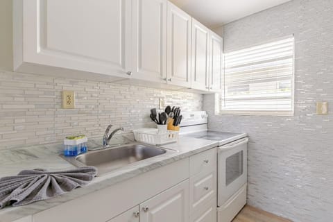 Functional kitchen with modern appliances and white cabinets.