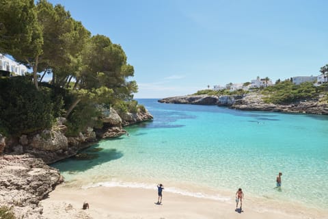 On the beach, white sand, sun loungers, beach umbrellas