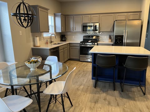 Open concept kitchen features new appliances and an oversized island.
