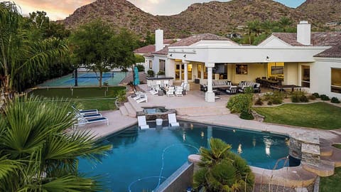 Luxury villa with a pool, hot tub, tennis court, and stunning mountain views.