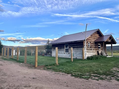 Side of cabin showing large fenced yard