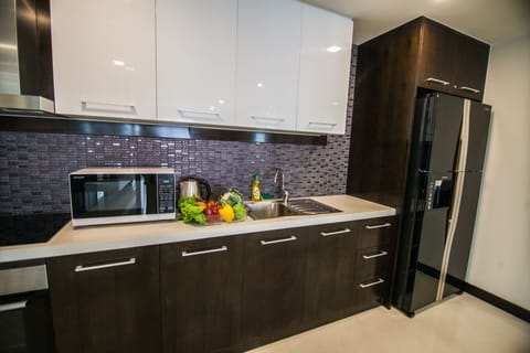 Two Bedroom Executive Suite | Private kitchen | Fridge, microwave, oven, stovetop