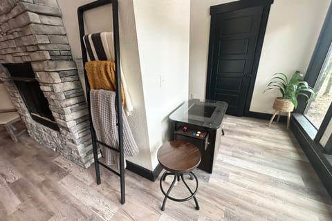 Classic vibes with a mini arcade game, warm stone fireplace, and chill-out spot. Perfect for winding down after adventure-packed days.