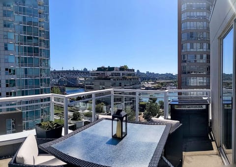 Main large deck off the living area with outdoor dining set with water views.