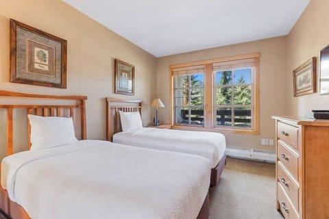 Twin bed room offers a lot of natural light from windows.