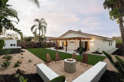Private backyard with fire pit, hot tub, outdoor dining and lounge areas.