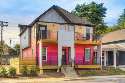 Comfortably entertain your large group in 2 beautifully updated condos. You'll recognize the house by the ombre sunrise paint.