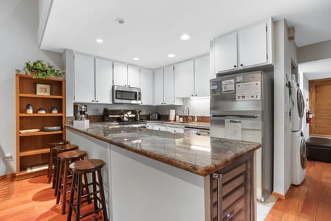 Culinary Dream: A well-appointed kitchen with sleek stainless steel fixtures and a dedicated wine fridge.