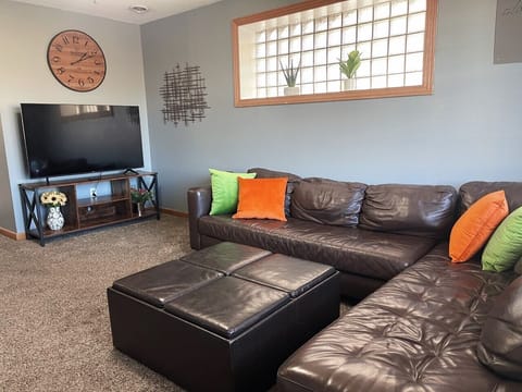 Big comfy leather couch for lounging or sleeping. Watch a show on 60" smart tv