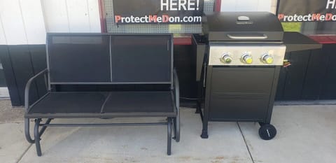 Enjoy outside on the covered patio. Glider and grill out the front door.