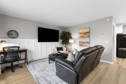Enjoy your favorite shows on our 75in Smart TV and Double Recliner Sofa