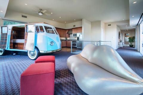 Modern loft with open layout, vintage VW van, and stunning city views.