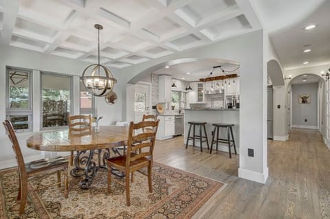 Gather around our beautiful wooden table in a cozy, rustic dining room that exudes warmth and charm.