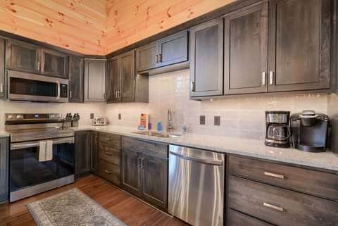 Kitchen with basic cooking supplies and a regular drip coffee pot and a Keurig