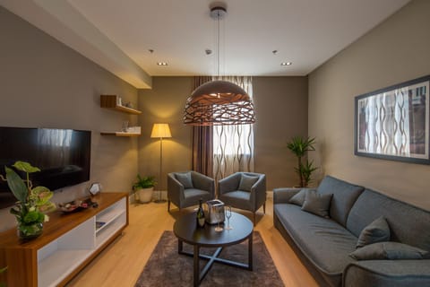 Premium Suite | Living room | 107-cm LCD TV with satellite channels, TV, iPad