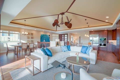 View of the living room, kitchen, dining table and vaulted ceiling